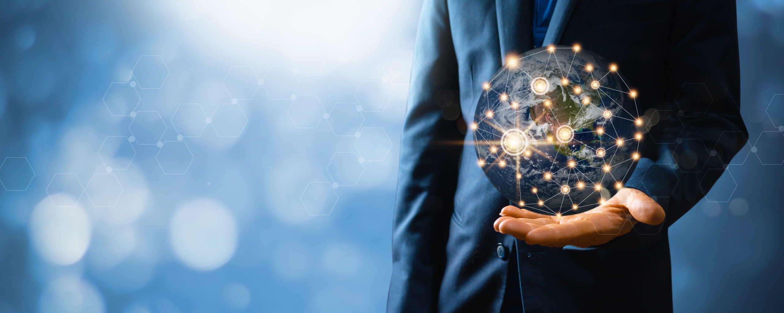 Businessman holding a glowing globe